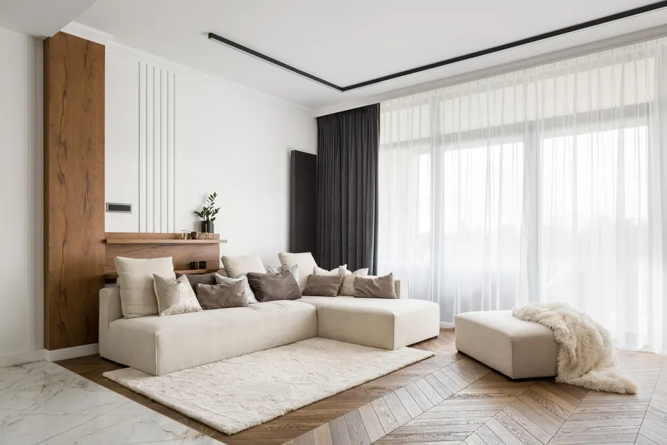 Sheer and blockout curtains framing a bright living room.