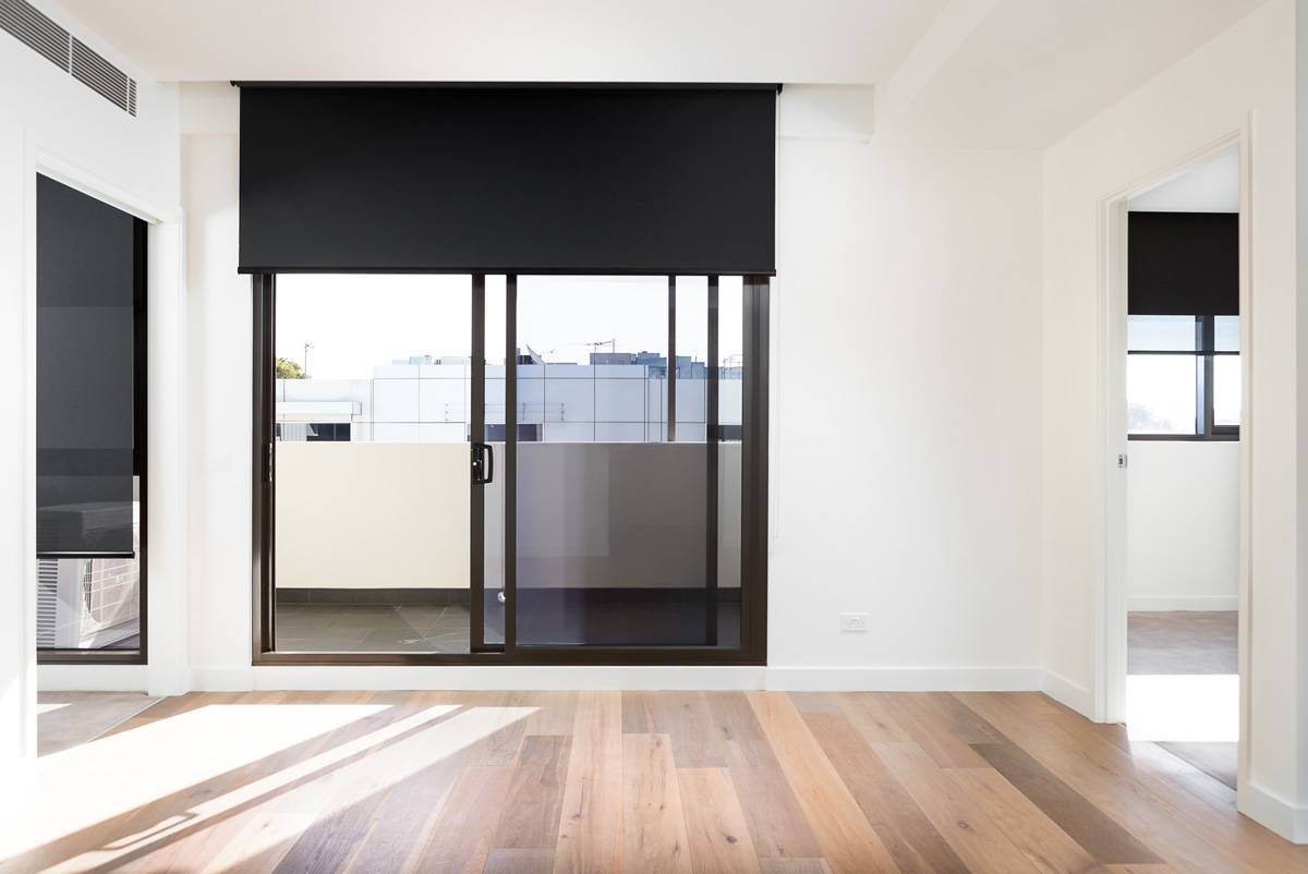 Blockout roller blinds creating complete darkness in a bedroom
